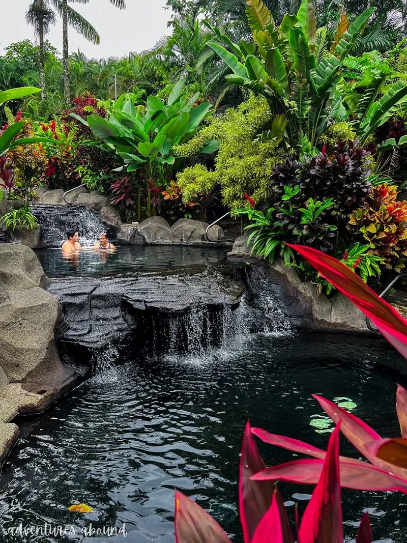 Couple relaxing in hot springs in La Fortuna