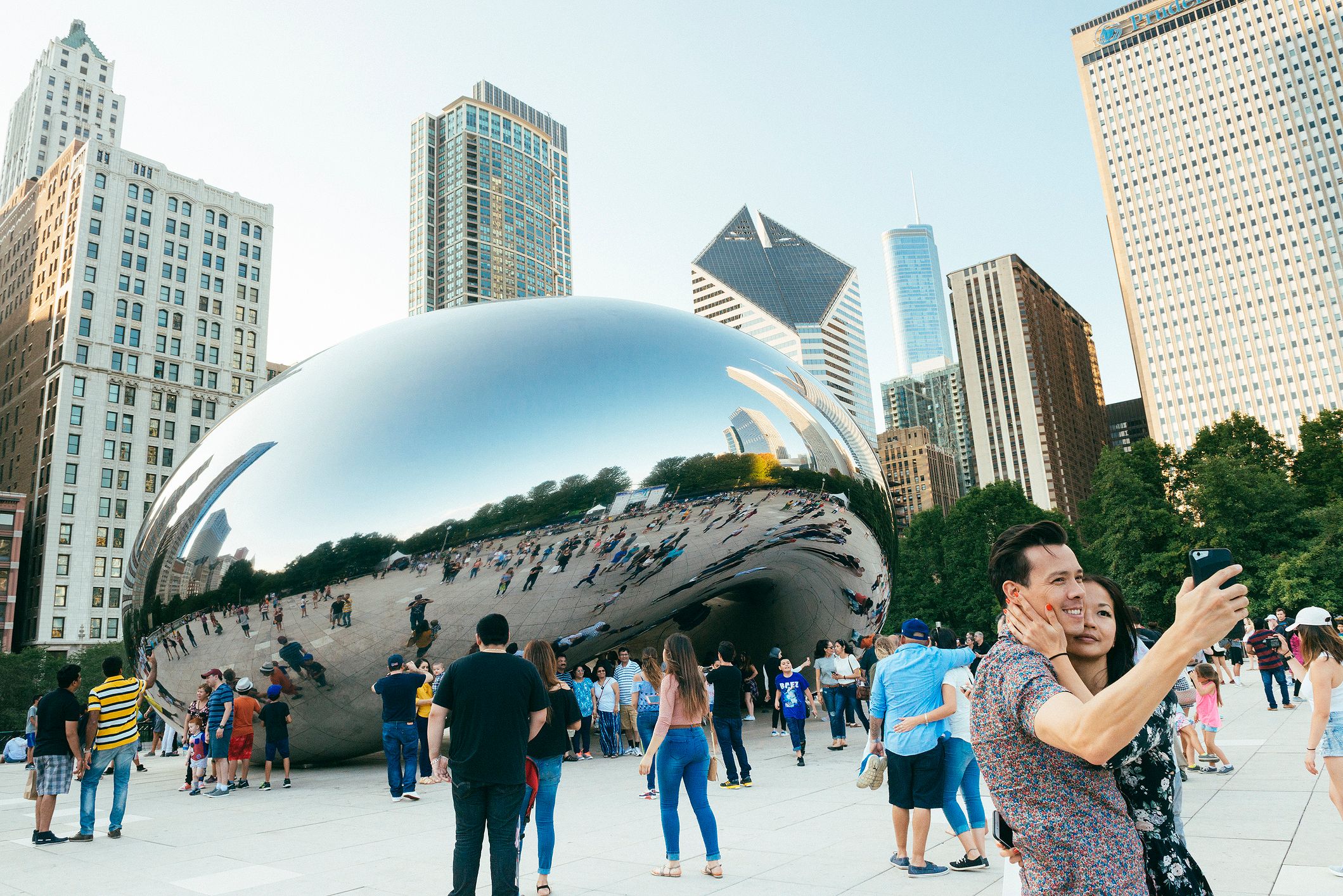 Crowds pose around the famous Cloudgate sculpture in Millennium Park